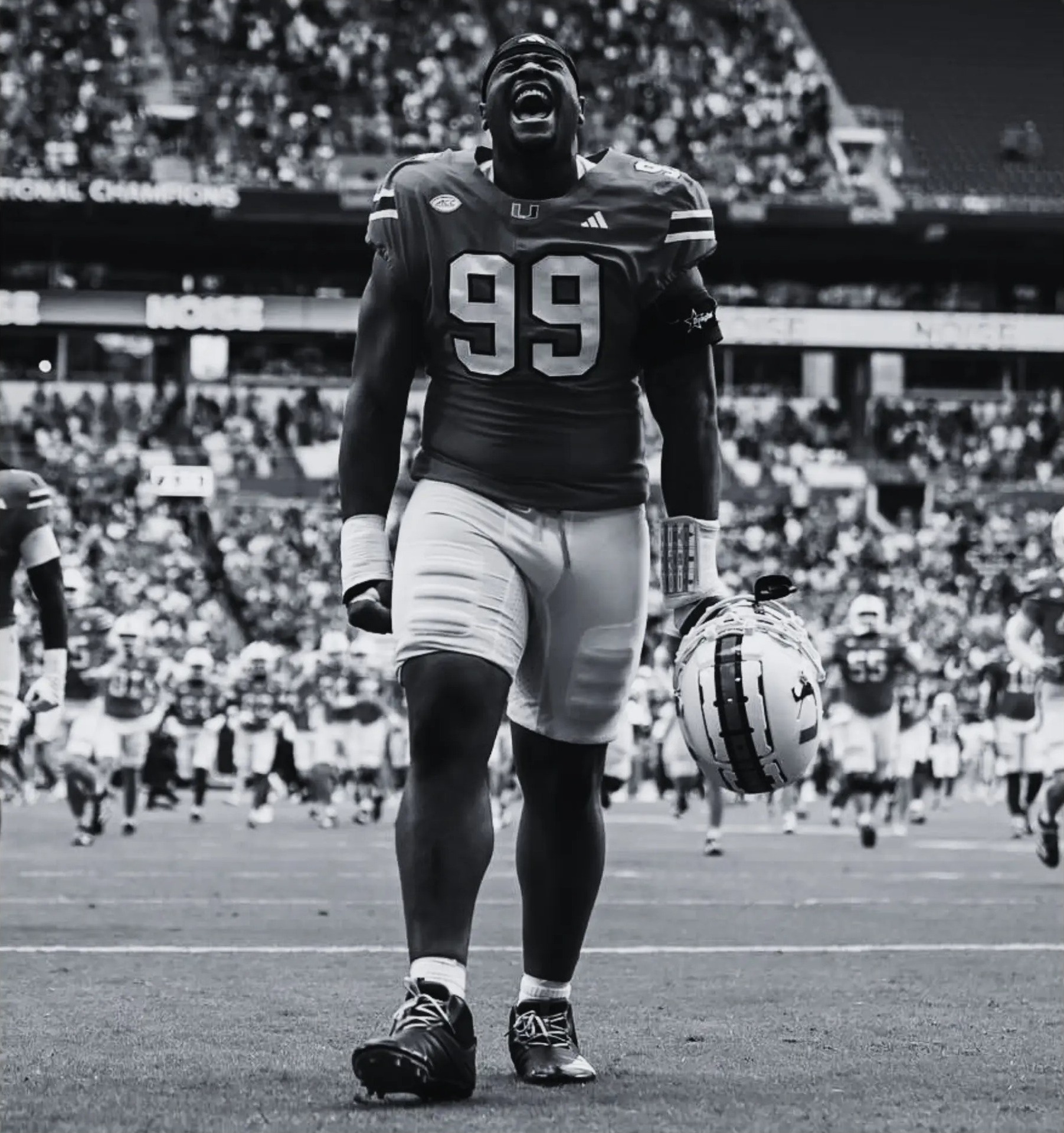 Ahmad Moten in his Miami Hurricanes #99 jersey roaring as he walks off the field